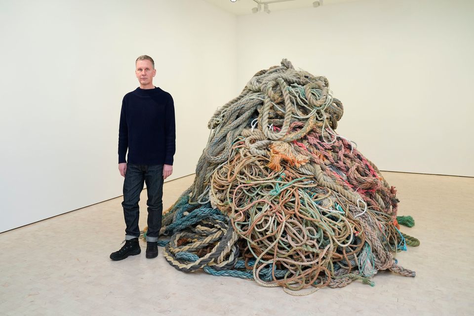 Artist David Shrigley with his new artwork 'Exhibition of Old Rope' at the Stephen Friedman Gallery in central London. Lucy North/PA Wire